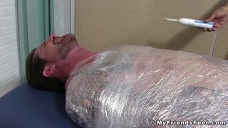 Jock Clint wrapped up to have his feet tickled BDSM style 2